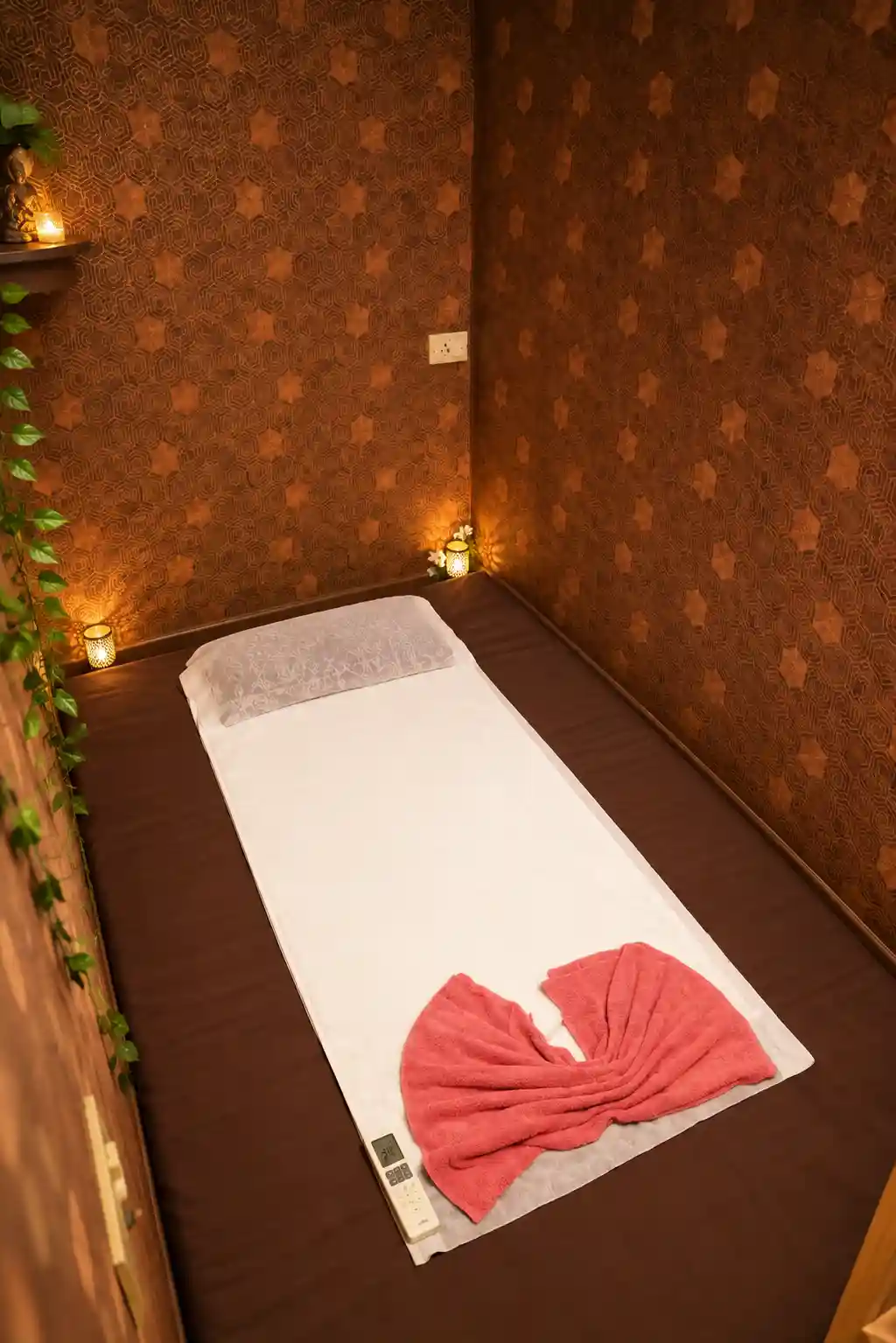 Candle-lit massage room with floor mattress